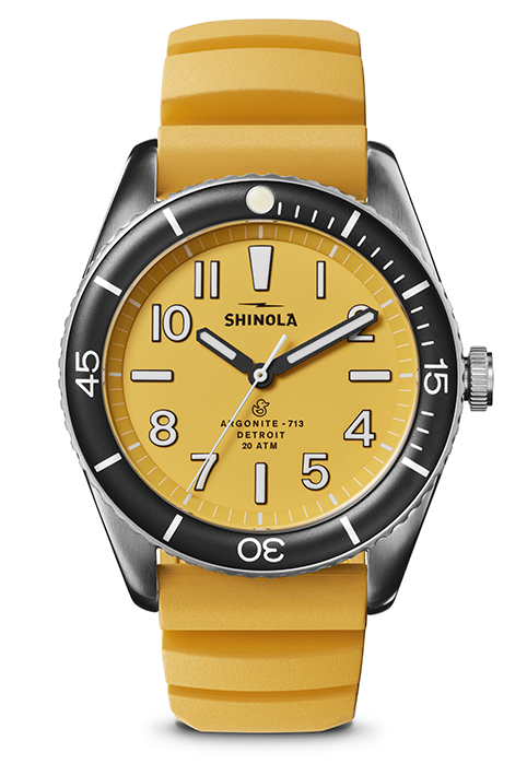 yellow and black men’s watch by Shinola