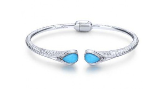 a white gold bangle bracelet featuring two turquoise gems