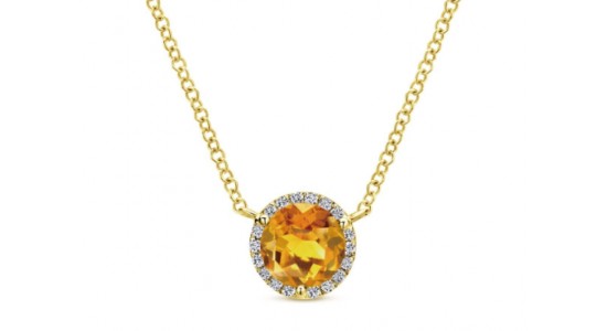 a yellow gold necklace featuring a halo set, round cut citrine