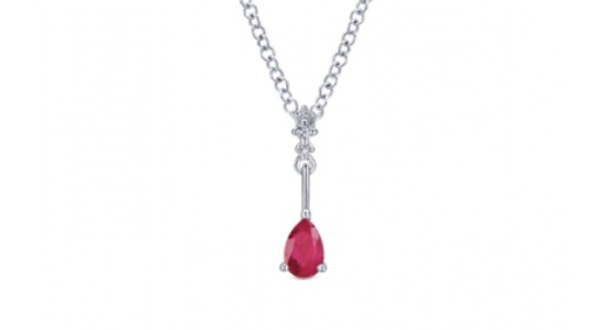 a white gold pendant necklace featuring diamonds and a ruby