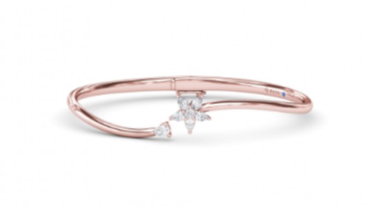a rose gold cuff bracelet featuring diamonds arranged into a star
