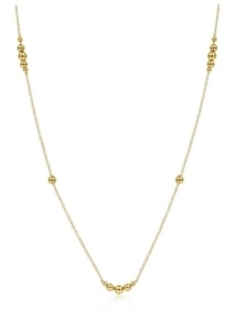 A gold chain necklace with gold accents from Gabriel & Co.