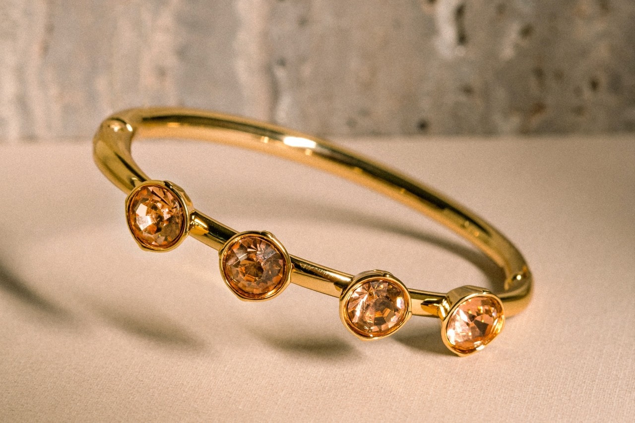 a yellow gold fashion ring dotted with three bezel-set citrine gems