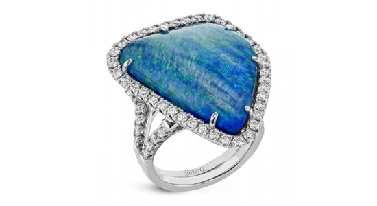 a white gold fashion ring featuring a large opal stone and accent diamonds