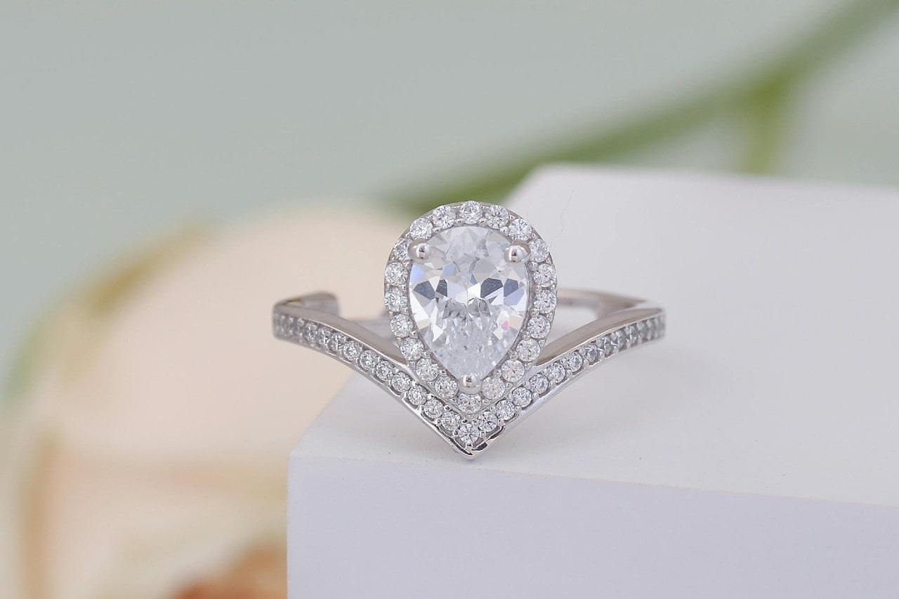 a platinum engagement ring resting on a table