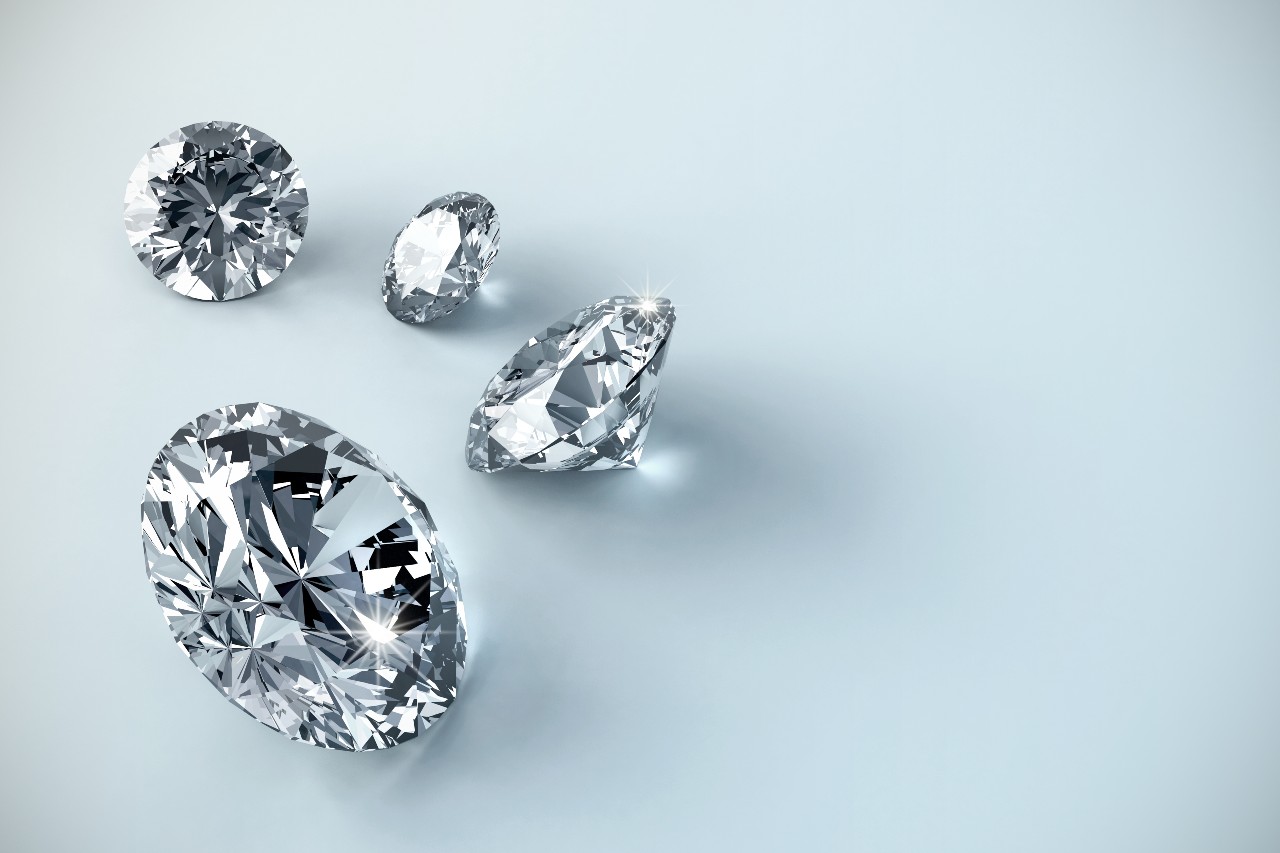 A group of different-sized diamonds sit on a blue background.