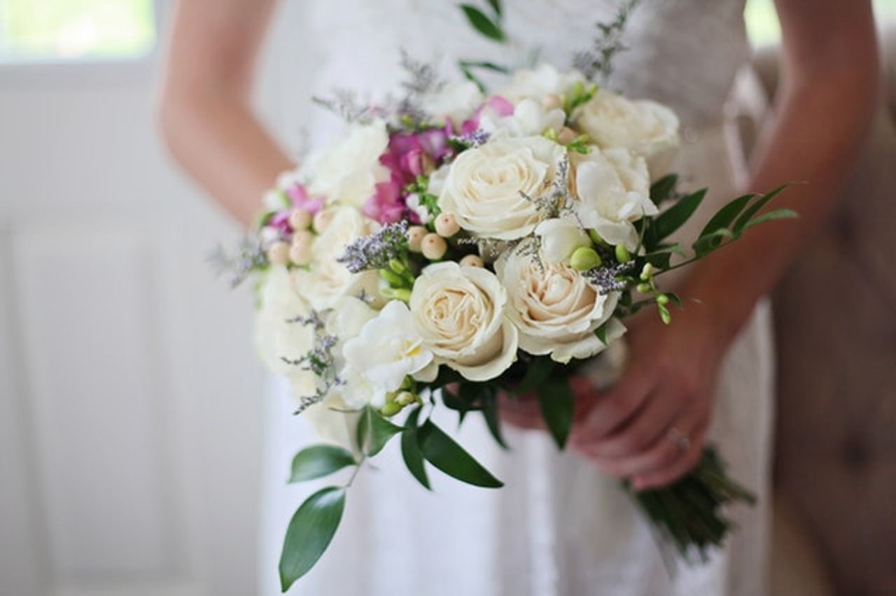 A closeup of a bride’s bouquet before a wedding.