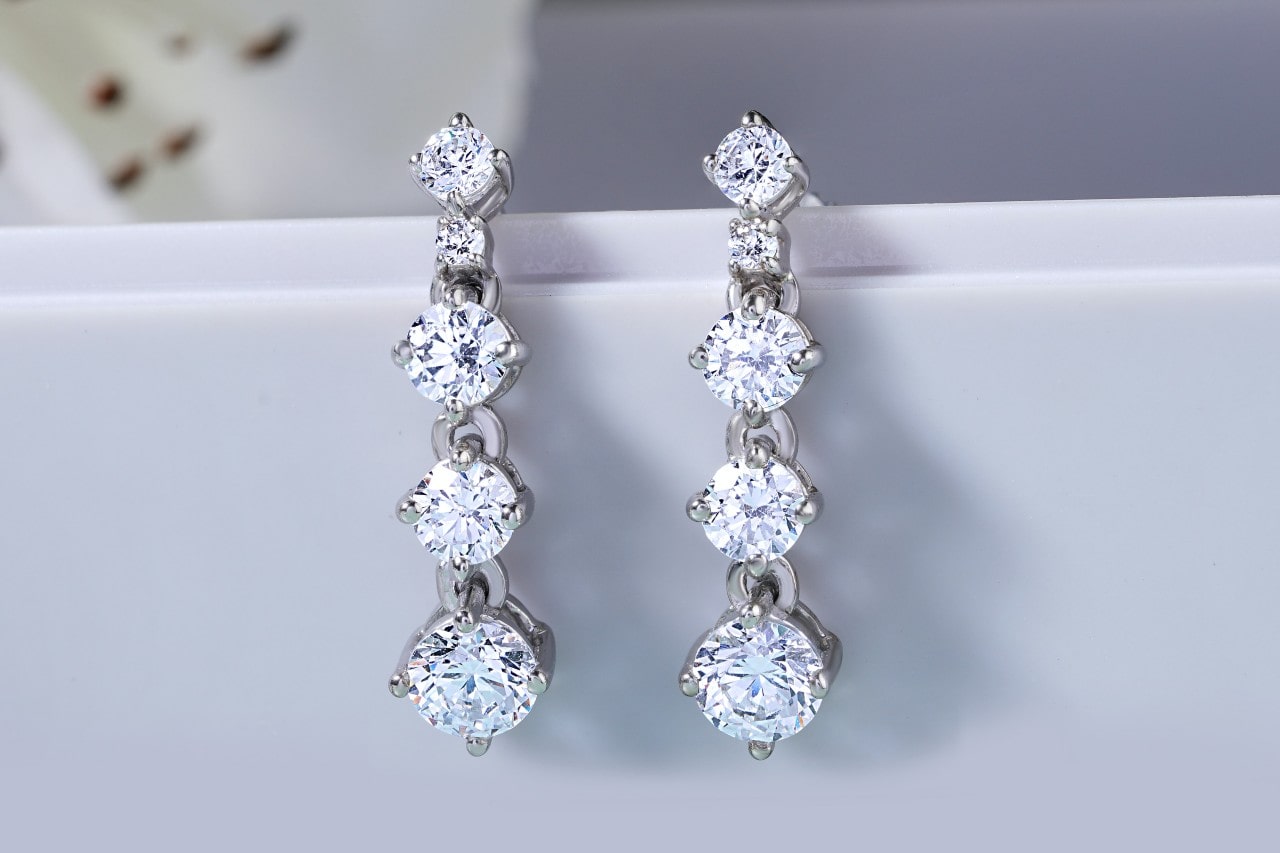 A pair of four-tiered, diamond earrings